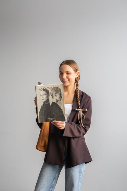 Vegan leather bow on a gold-plated clip