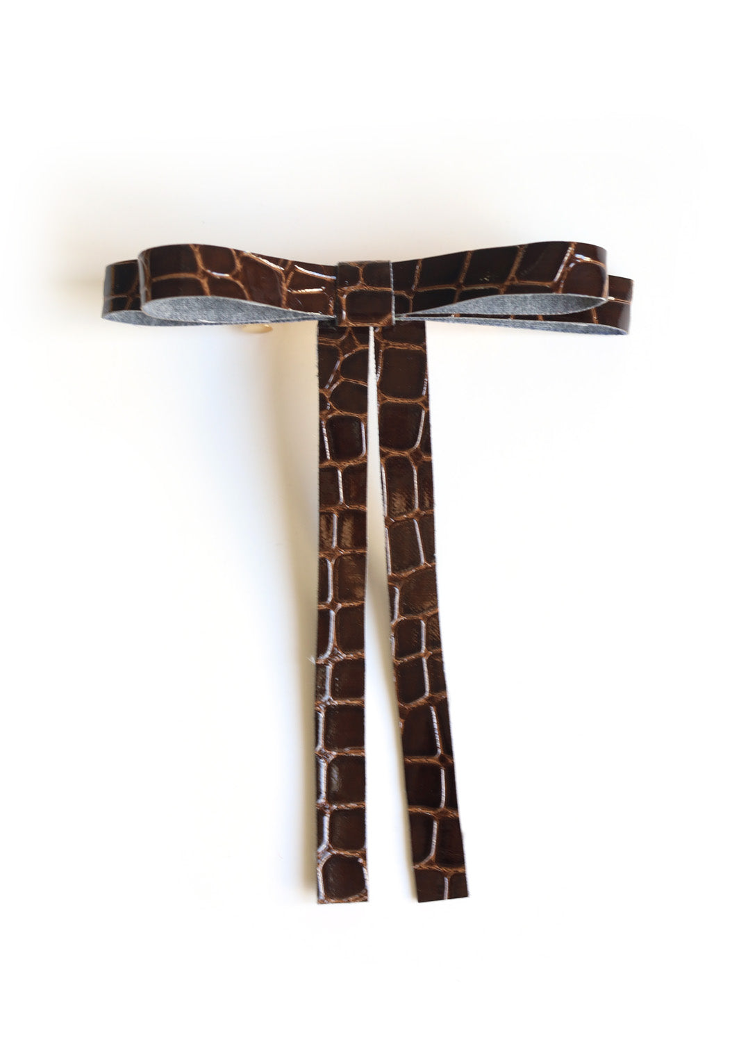 Vegan leather bow on a gold-plated clip