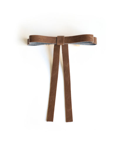 Vegan leather bow on a gold-plated clip